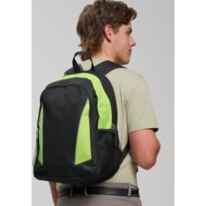 A black and neon green backpack is worn on the back of a young man, featuring mesh pockets and zippers.