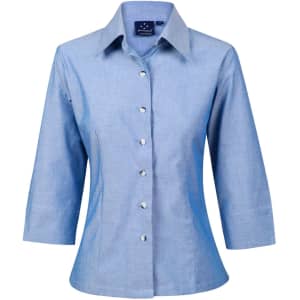 A light blue chambray shirt with 3/4 sleeves and a button-up front. The shirt features a collar and has a logo.