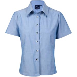 A short-sleeve ladies' button-up shirt in light blue chambray with a collar and shiny buttons.