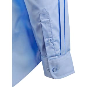 A light blue button-up shirt featuring epaulettes, with a structured sleeve and buttoned cuff. It has a logo.