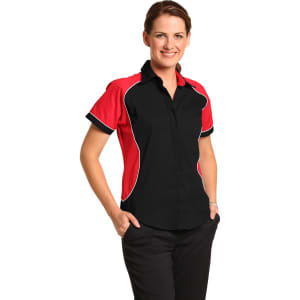 A woman models a women's button-up shirt featuring a black base with red contrast panels and a logo.