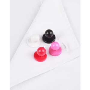 A set of four exchangeable buttons in white, black, red, and pink resting on a white chef uniform.