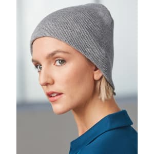 A grey acrylic knitted marl beanie displayed on a model, featuring a fitted design and a subtle texture.