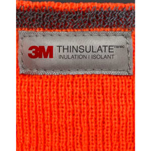 An orange Thinsulated cuff beanie with a grey label featuring branding and care information.