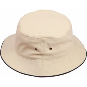 A soft washed bucket hat in cream with a contrasting black trim, featuring eyelets and a branded logo.