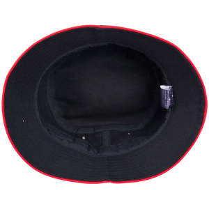 A black bucket hat with a red contrast brim and interior. The hat features a label inside.