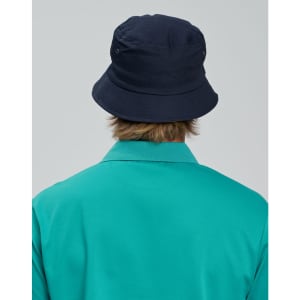 A navy bucket hat with a contrasting underbrim, shown from the back, paired with a teal shirt.