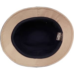 A bucket hat with a navy interior and a light beige exterior, featuring a logo inside.