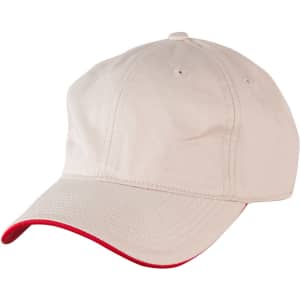 A beige cap with a contrasting red peak, featuring ventilation holes and a logo.
