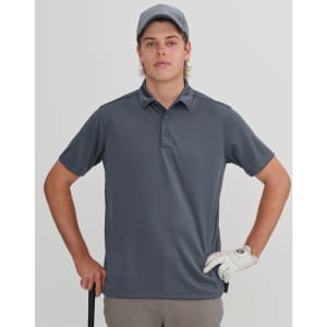 A young man in a grey polo shirt and cap holds a golf club, wearing a golf glove. The background is neutral.