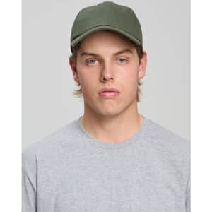 A green cotton twill unstructured cap worn by a young man in a grey t-shirt, featuring a logo.