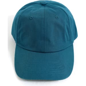 A cotton twill unstructured cap in a teal colour, featuring a logo on the front.