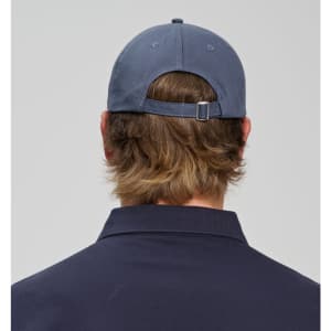 A navy blue cotton twill unstructured cap with an adjustable strap at the back, seen from the rear.