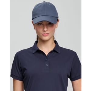 A navy cotton twill unstructured cap worn by a model, featuring a logo on the front.