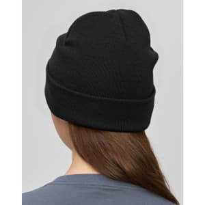 A black beanie made from rPET, displayed from the back on a model with long hair. It features a logo.