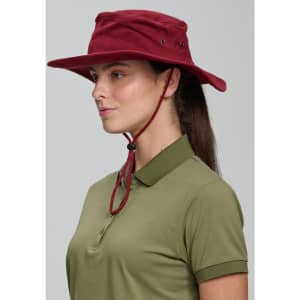 A burgundy bucket hat with a chin strap displayed on a person wearing a green polo shirt. Features a logo.