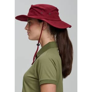 A burgundy surf hat with a wide brim and adjustable chin strap, worn by a person in profile.