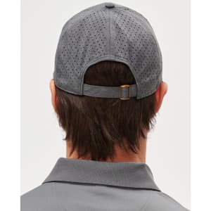 A grey cap with a laser cut design, featuring a rear adjustable strap and a logo.