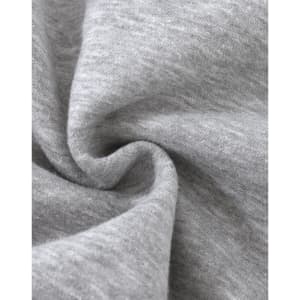 A close-up of soft, grey fabric with a slight texture, typical of a fleece jumper. It features a logo.
