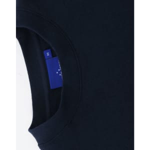 A navy crewneck sweatshirt with a ribbed collar and a logo tag visible on the inside seam.