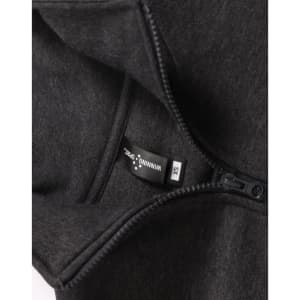A 1/2 zip collar fleecy jumper in dark grey, featuring a hang tag and a zip closure. It has a logo.