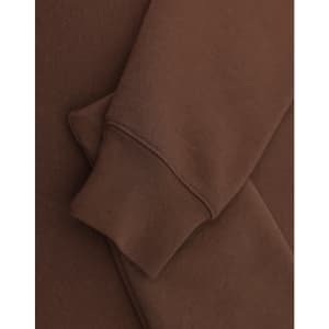 A brown 1/2 zip collar fleecy sweat featuring a smooth fabric and a cuffed sleeve. Includes branding.