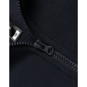 A close-up of a navy 1/2 zip collar fleece sweatshirt featuring a zipper and a tag.