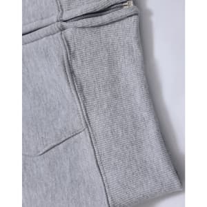 A grey fleecy hoodie featuring a full zip and ribbed cuff detail. It includes pockets and has a logo.