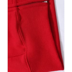 A close-up of a red fleecy hoodie featuring a full-zip and zippered pocket. The fabric appears soft and textured.