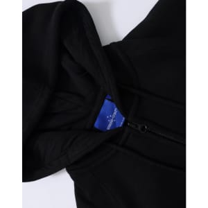 A black ladies' full-zip fleecy hoodie featuring a hood and a zipped front, with an inner label visible.