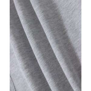 A close-up of soft grey fabric, highlighting multiple folds and textures of a fleecy hoodie.
