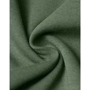 A close-up view of soft, green fabric, showcasing its texture and weave. It has a smooth, layered appearance.
