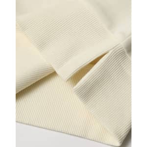 A close-up of a cream-coloured unisex crew neck sweater, featuring ribbed cuffs and hem. It has a logo.