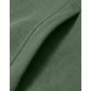 A close-up of a green fleece hoodie showcasing its soft fabric and stitching details. The hoodie has a logo.