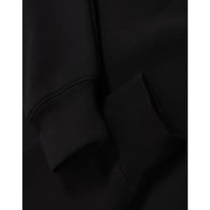 A black unisex premium fleece oversized hoodie with ribbed cuffs. The fabric appears soft and cozy.
