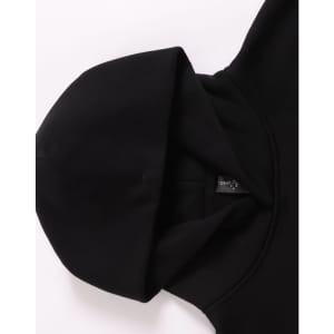 A black unisex premium fleece oversized hoodie, featuring a large hood and a simple design. It has a logo on the label.