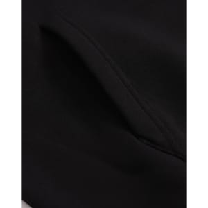 A close-up of a black unisex premium fleece oversized hoodie, highlighting the fabric texture and stitching details.