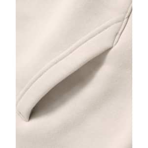 A close-up of a cream-coloured premium fleece oversized hoodie featuring a side seam pocket.
