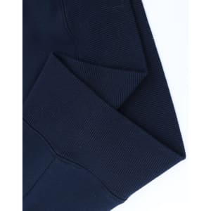 A close-up of the cuff detailing on a navy unisex premium fleece oversized hoodie, featuring a ribbed texture.