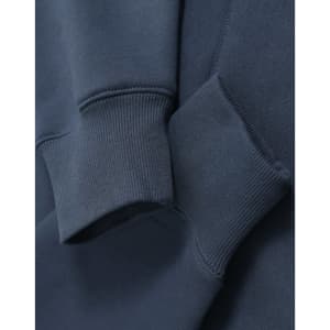 A close-up of blue fleece fabric featuring ribbed cuffs of an oversized unisex hoodie with a logo.