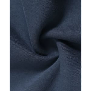 A close-up of soft, navy fleece fabric, showcasing its texture and smoothness, with a logo visible.