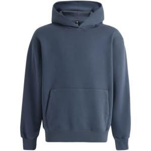 A unisex oversized hoodie in navy blue with a front pocket and a hood. It features a logo on the inside label.