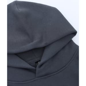 A grey unisex premium fleece oversized hoodie with a large hood, featuring a branding label.