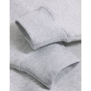 Close-up of a light grey fleece oversized hoodie featuring ribbed cuffs and a soft texture.