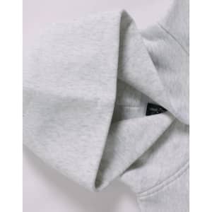 A grey oversized hoodie featuring a hood and a label inside, with a soft fleece texture.