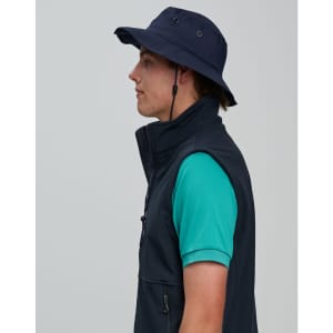 A navy blue bucket hat with a clip-on chin strap, worn by a person in a green shirt and black vest.