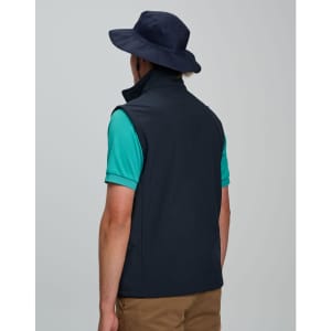 A navy surf hat with a clip-on chin strap, worn by a person in a green shirt and navy vest.
