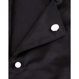 A close-up of a black chef jacket featuring two white exchangeable buttons on the collar.