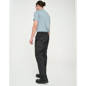 Lightweight nylon waterproof rain pants in black, modelled by a person wearing a blue T-shirt and black shoes.