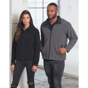 A black and grey softshell jacket worn by a woman and a man, featuring a zip closure and a logo.